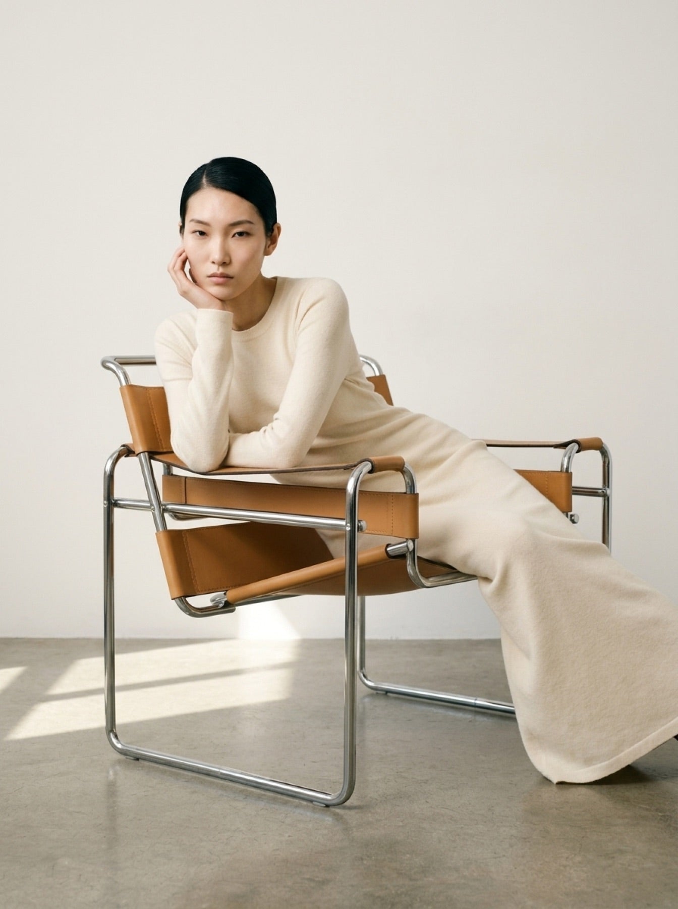 Cream knit floor-length dress in a minimalist interior